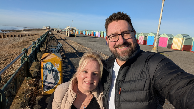 Image of Andrew and a woman by the beach