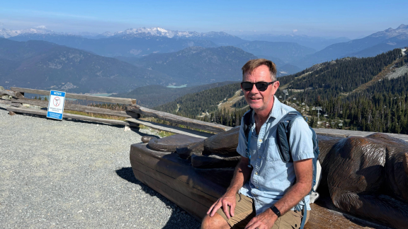 Image of Ian in front of a mountain view 