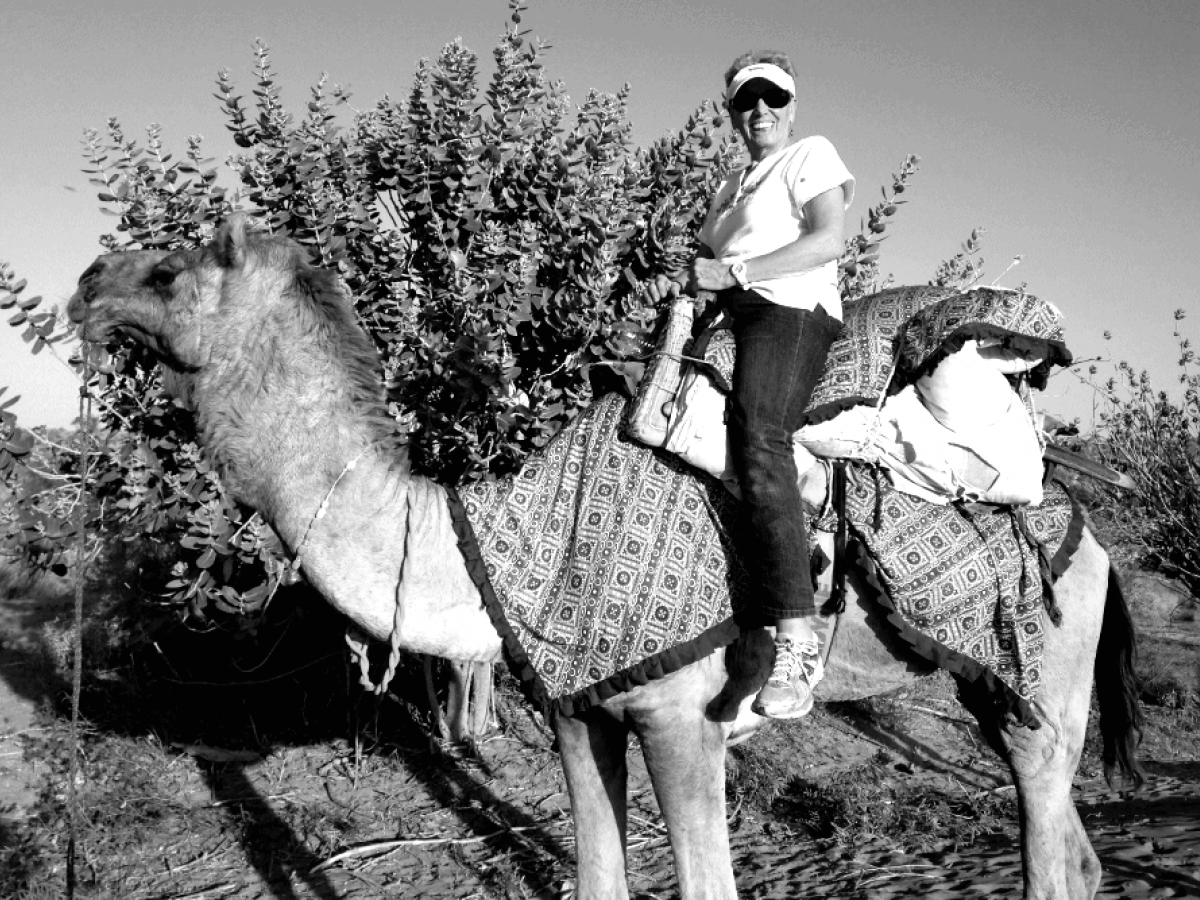 Woman riding camel