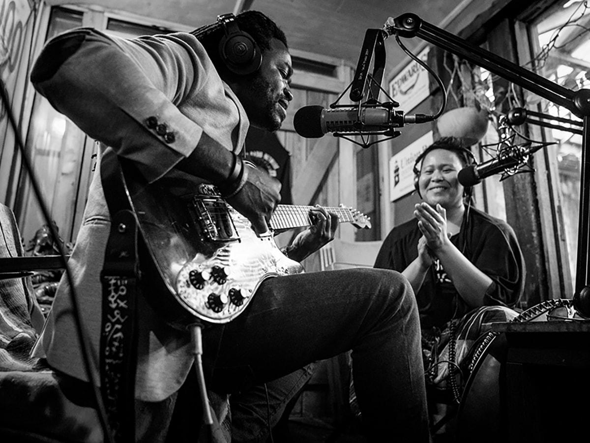 Man playing guitar with woman clapping