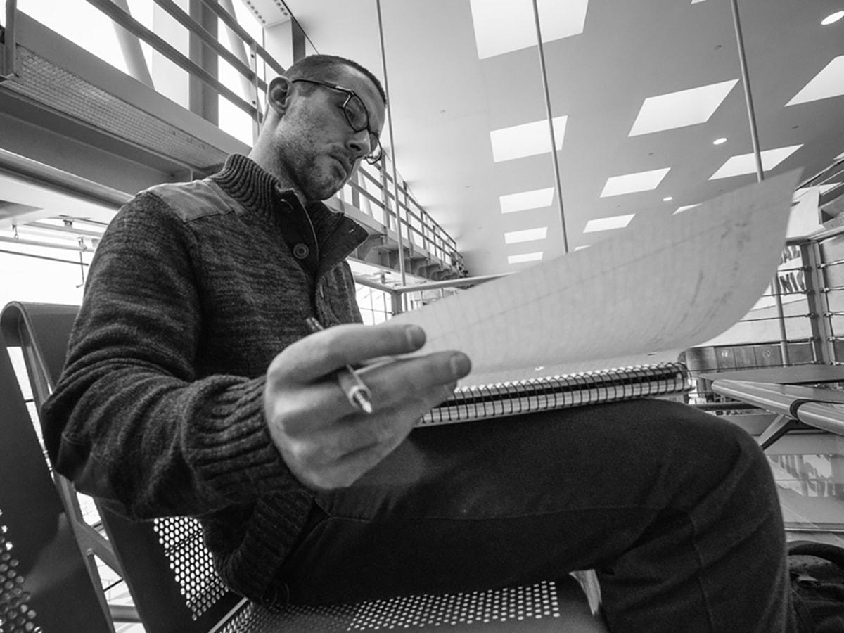 Man taking notes on bench