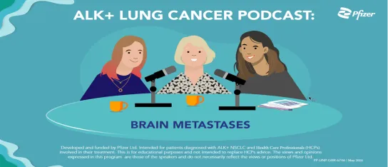 Image of 3 ladies sitting at a table with a microphone