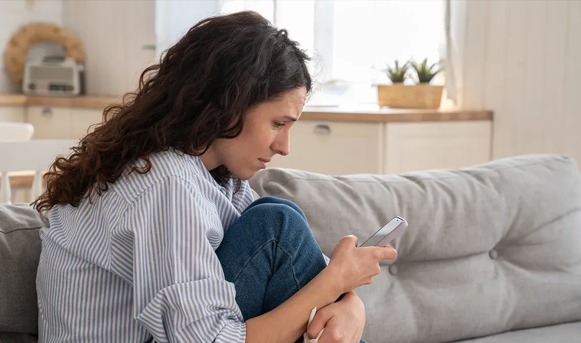 Woman sitting on a couch.