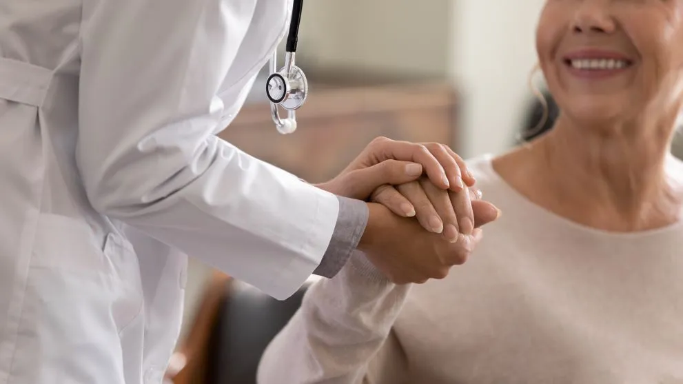Doctor holding the hand of a woman 