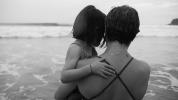 Woman holding child at beach